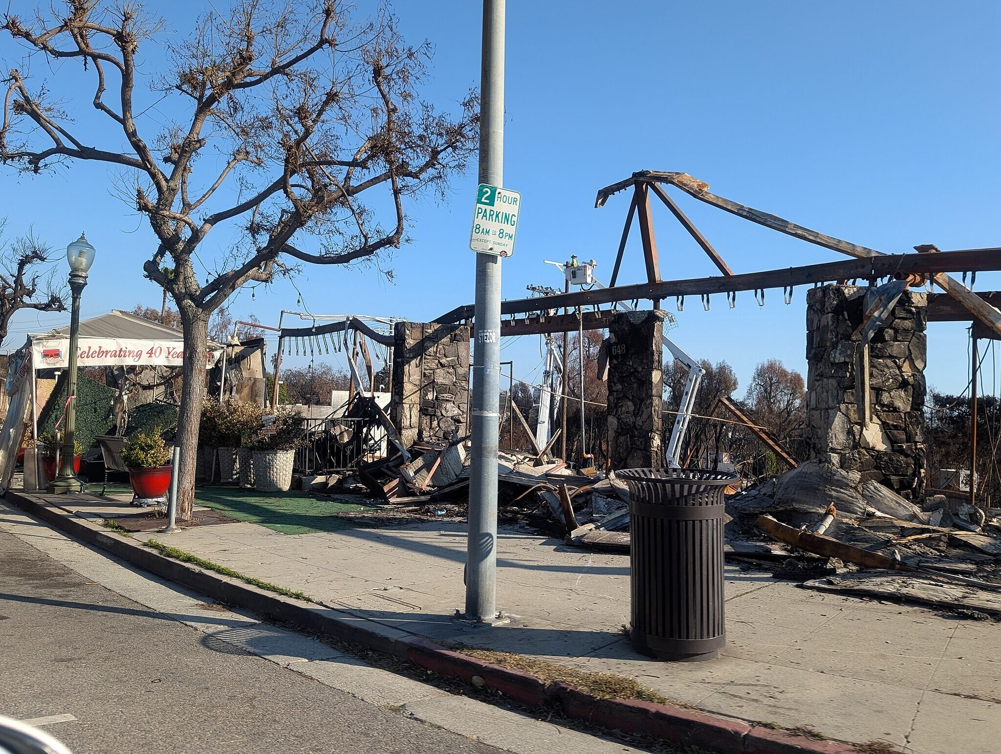 Burnt-out neighborhood in Altadena showing wildfire damage and destroyed homes, highlighting the urgency of rebuilding with fire-resilient construction.